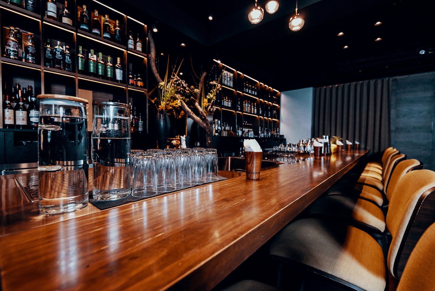 Modern empty night bar, wide angle near bar counter.